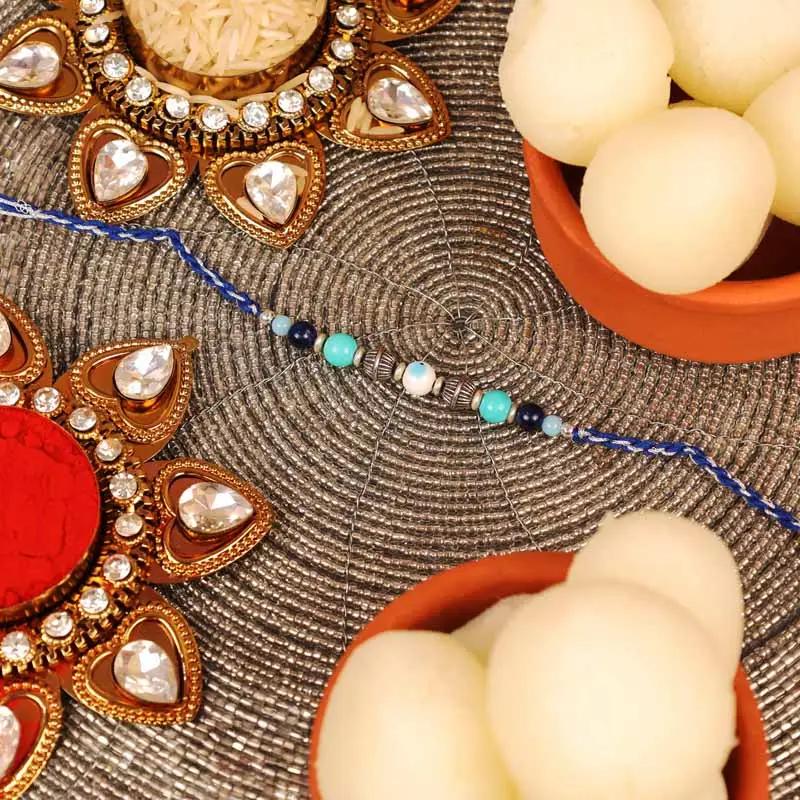 Evil Eye Rakhi and Tin Rasgulla
